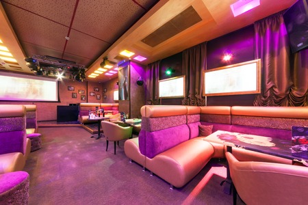MOSCOW - AUGUST 2014: Modern interior of the main hall of the restaurant-karaoke "BRUSOFF". Table with high sofaのeditorial素材