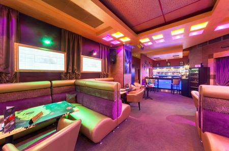 MOSCOW - AUGUST 2014: Modern interior of the main hall of the restaurant-karaoke "BRUSOFF". Table with high sofaのeditorial素材