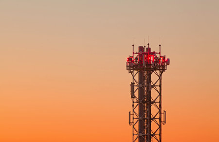 Mobile phone Telecommunication Radio antenna at the top of the pipe with sunset sky