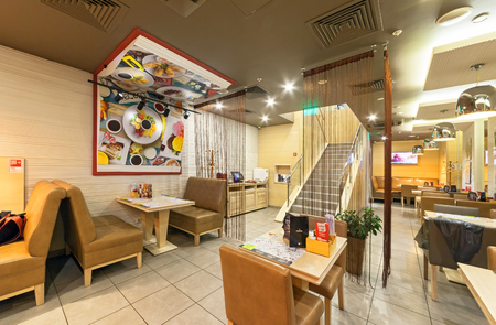 MOSCOW - AUGUST 2014: The interior of chain cafe pan-Asian cuisine - "Menza". The tables with chairs without visitorsのeditorial素材