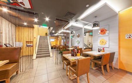 MOSCOW - AUGUST 2014: The interior of chain cafe pan-Asian cuisine - "Menza". The tables with chairs without visitorsのeditorial素材