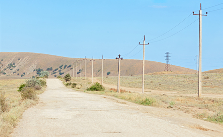 The old road in the arid region with concrete poles for electricity along the curb. Peninsula of Crimeaの写真素材