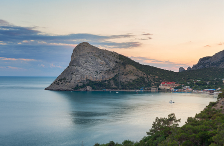 Large headland in the sea near the resort town in the Bay at sunset. Cape Chyken Peninsula of Crimea, resort Noviy Svetの写真素材