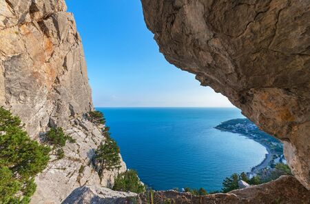 The view of the sea and of the coastline through a big cleft in the rock. The Mountains Of The Crimeaの写真素材