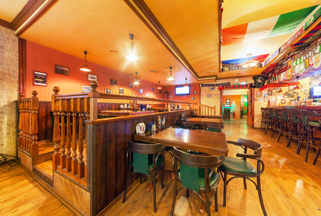 MOSCOW - AUGUST 2014: Interior of the Irish pub and sports bar "Boston". Main hall with wooden furniture and sports attributesのeditorial素材