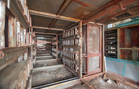 Old broken and rusted equipment of an abandoned textile factoryの写真素材