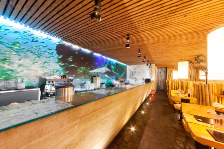MOSCOW - AUGUST 2014: Interior of the Japanese sushi restaurant chain "TANUKI". A long counter open kitchen in the restaurant hallのeditorial素材
