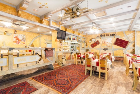 MOSCOW - AUGUST 2014: Interior of the restaurant "RIO GRANDE". Hall of yellow color, decorated in a farmer's style with wooden furnitureのeditorial素材