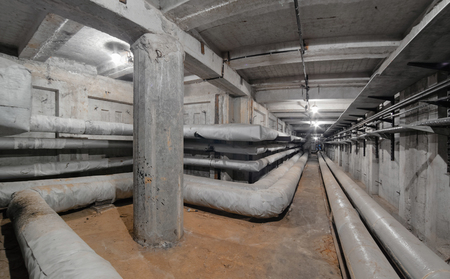 Special bending of the heating main pipe in underground concrete utility tunnel network of water supply pipeline, heat pipeline and cable vaultの写真素材