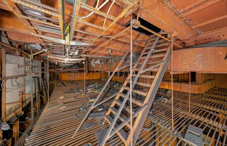 Completely rust-covered iron room with iron stairs in an abandoned old Soviet industrial laboratoryの写真素材