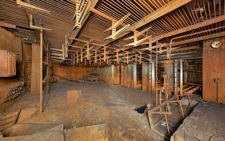 Rusty iron room with hooks for electrical cables in an abandoned scientific industrial laboratoryの写真素材