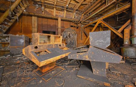 Old broken and covered with soot and rust retro control panels in abandoned industrial laboratory after fireの写真素材