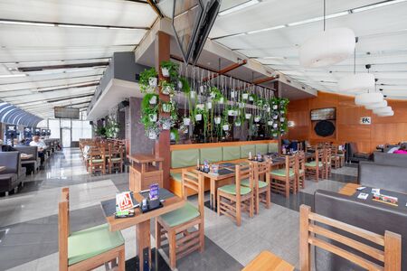 MOSCOW - SEPTEMBER 2014: The interior of the popular Japanese chain of restaurants "YAKITORIYA" in Moscow. Hall under the glass roof. Modern design with traditional Japanese styleのeditorial素材