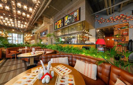 MOSCOW - OCTOBER 2014: The interior of the trendy restaurant "Oki Doki". Hall with semicircular leather sofas, bar counter and open kitchenのeditorial素材