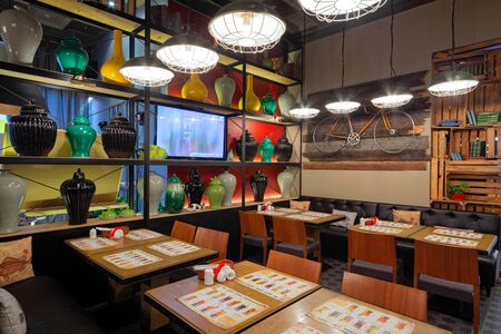 MOSCOW - OCTOBER 2014: The interior of the trendy restaurant "Oki Doki". Shelving with colorful vasesのeditorial素材