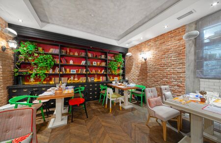 MOSCOW - OCTOBER 2014: The interior of the restaurant of Eastern European cuisine "Spices & Joy". Hall with a brick wall and a large black bookcaseのeditorial素材