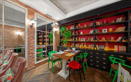 MOSCOW - OCTOBER 2014: The interior of the restaurant of Eastern European cuisine "Spices & Joy". Hall with a brick wall and a large black bookcaseのeditorial素材
