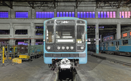 The metro cab is outside. Train over the service pit in a large industrial buildingのeditorial素材