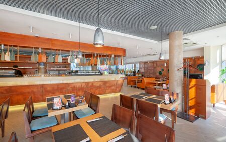 MOSCOW - SEPTEMBER 2014: The interior of the popular Japanese chain of restaurants in modern style "YAKITORIYA" in Moscow. Wooden bar counter decorated with boat oarsのeditorial素材