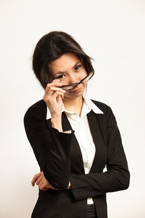 Attractive Asian working business woman shooting in isolated backgroundの写真素材