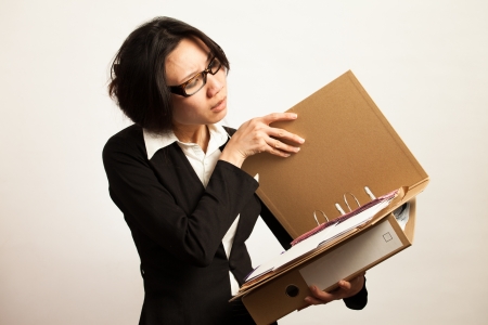 Attractive Asian working business woman shooting in isolated backgroundの写真素材