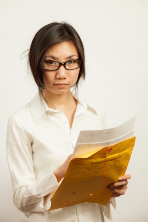 Attractive Asian working business woman shooting in isolated backgroundの写真素材