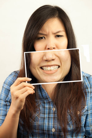 Asian woman pretend to smile