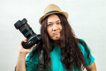 asian man in blue, with a camera