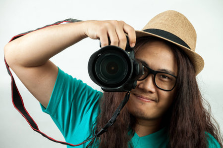 asian man in blue, with a camera