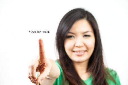 asian woman in green set, clicking a button or drawing linesの写真素材
