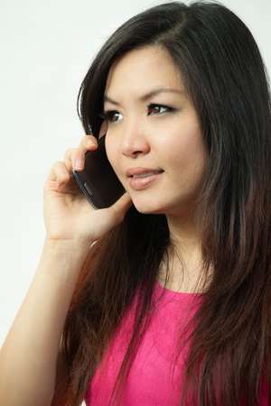 Beautiful asian woman holding a mobile phoneの写真素材