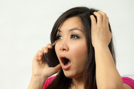 Beautiful asian woman holding a mobile phoneの写真素材