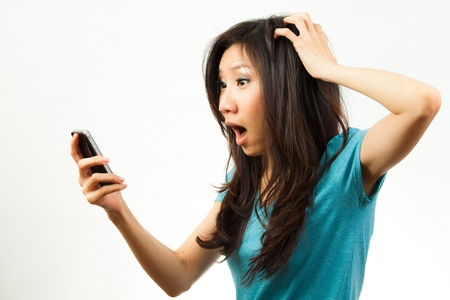 Beautiful asian woman holding a mobile phoneの写真素材