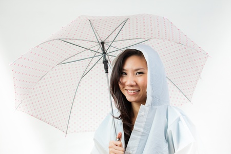 Asian women under the rain with an umbrellaの写真素材