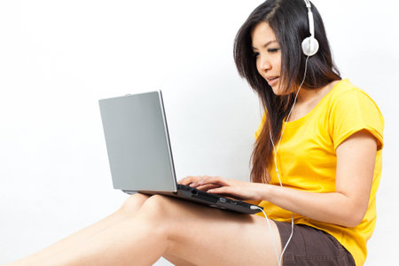 Asian woman playing with her laptopの写真素材