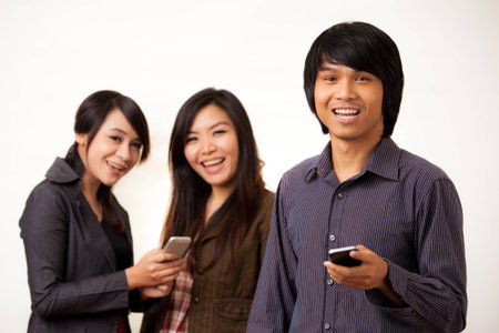 Group of Asian people enjoy their phoneの写真素材