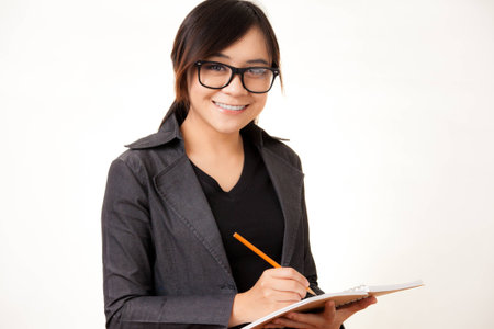 Attractive Asian working business woman shooting in isolated backgroundの写真素材