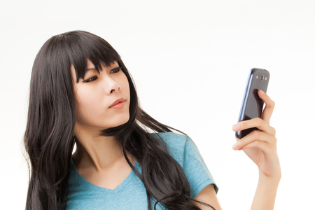 Group of Asian people enjoy their phoneの写真素材