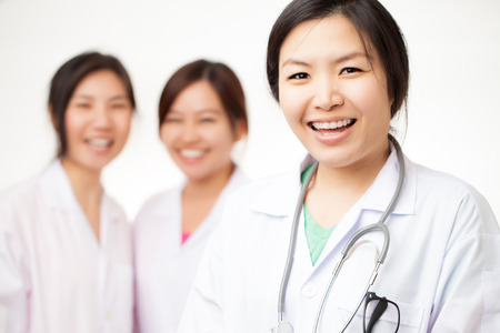 Asian female doctor shooting on white backgroundの写真素材