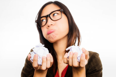 asian woman anoyed by the waste of paper and moneyの写真素材