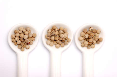spoons full of black peppercornの写真素材
