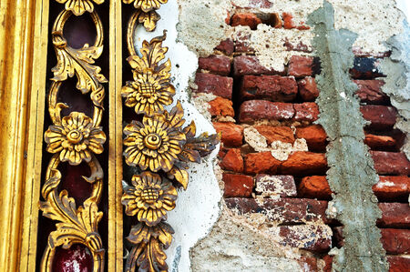 An antique wall of temple in Thailandの写真素材