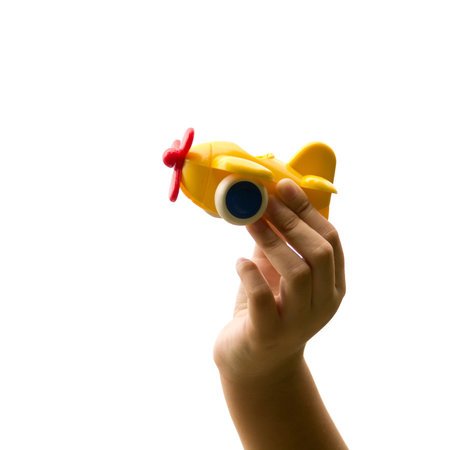 child hand holding plastic toy planeの写真素材