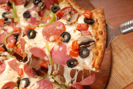 pepperoni pizza on wooden boardの写真素材