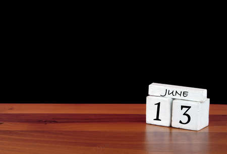 13 June calendar month. 13 days of the month. Reflected calendar on wooden floor with black backgroundの写真素材
