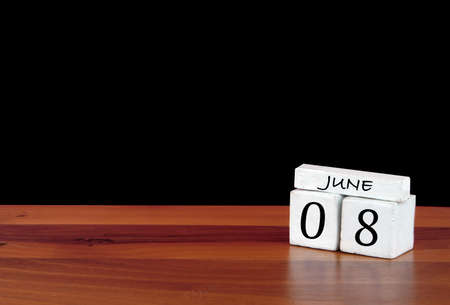 8 June calendar month. 8 days of the month. Reflected calendar on wooden floor with black backgroundの写真素材