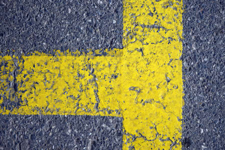 Yellow road warning line on the asphalt road. For backgroundの写真素材