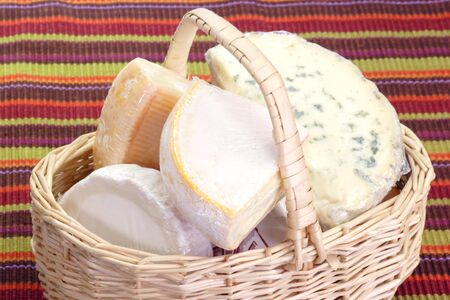 French soft cheese in a basket on colored backgroundの写真素材
