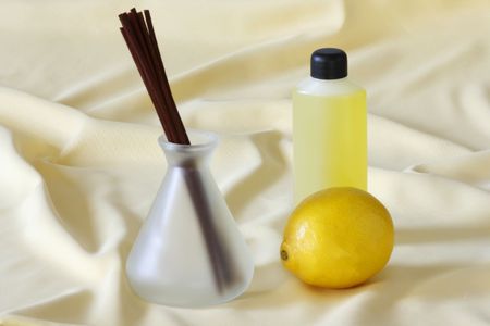 Wooden sticks in essential oil with lemonの写真素材