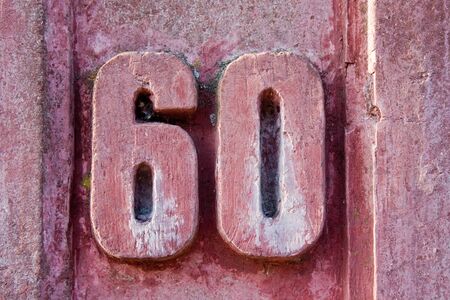 House number 60 on an old wallの写真素材
